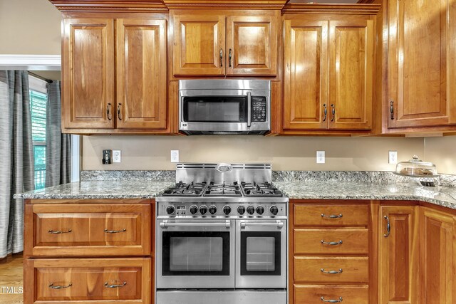 319 River Knoll Dr, Clayton, NC 27527 - kitchen featuring brown cabinetry and appliances with stainless steel finishes