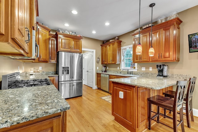 319 River Knoll Dr, Clayton, NC 27527 - kitchen featuring a peninsula, brown cabinets, and stainless steel appliances