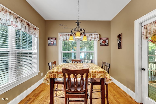 319 River Knoll Dr, Clayton, NC 27527 - dining room featuring a chandelier, light wood-style floors, and baseboards