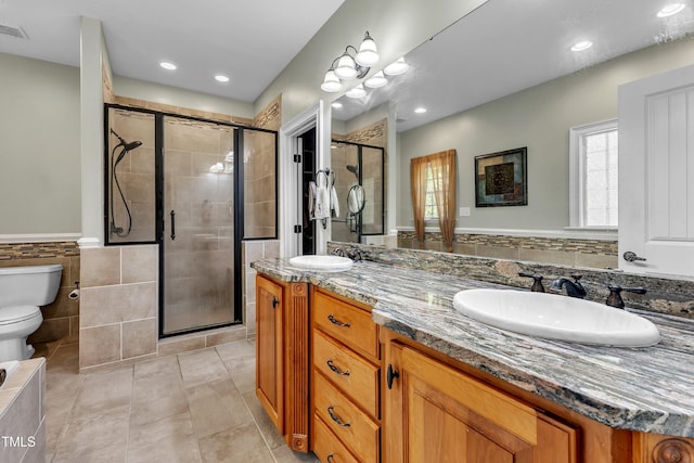 319 River Knoll Dr, Clayton, NC 27527 - full bathroom with a sink, toilet, double vanity, tile patterned flooring, and a stall shower