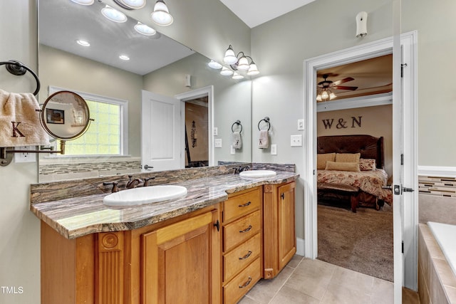 319 River Knoll Dr, Clayton, NC 27527 - bathroom with a sink, ceiling fan, connected bathroom, and tile patterned flooring
