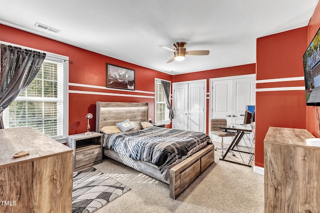 319 River Knoll Dr, Clayton, NC 27527 - carpeted bedroom featuring visible vents, multiple closets, and ceiling fan