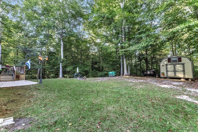 319 River Knoll Dr, Clayton, NC 27527 - view of yard featuring an outbuilding, a wooden deck, and a storage unit
