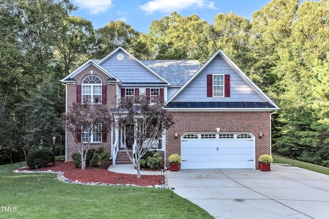 319 River Knoll Dr, Clayton, NC 27527 - view of front of property featuring driveway, a garage, a front lawn, brick siding, and a standing seam roof