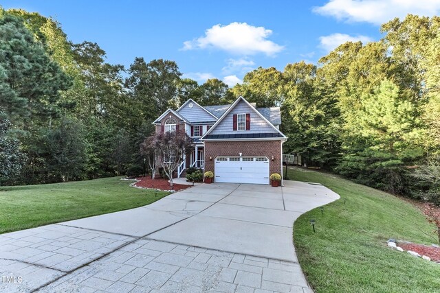 319 River Knoll Dr, Clayton, NC 27527 - view of front of property featuring concrete driveway, a front yard, brick siding, and an attached garage