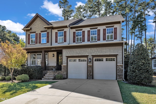 craftsman house featuring a front yard and a garage