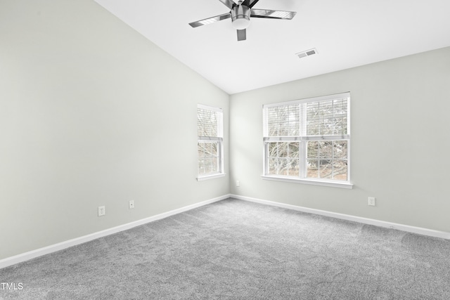 carpeted empty room featuring ceiling fan and lofted ceiling