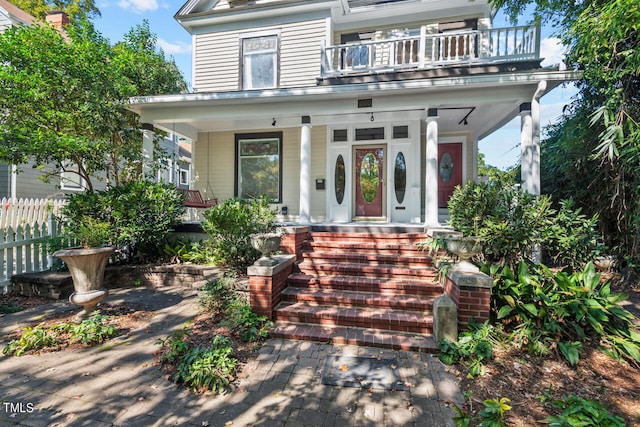 view of front of home with a balcony and covered porch