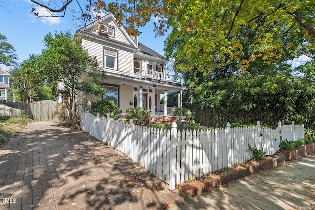 view of front of house featuring a balcony and a porch