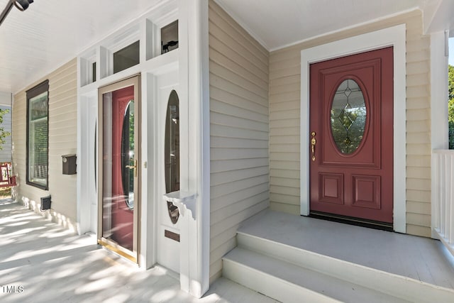 view of exterior entry with a porch