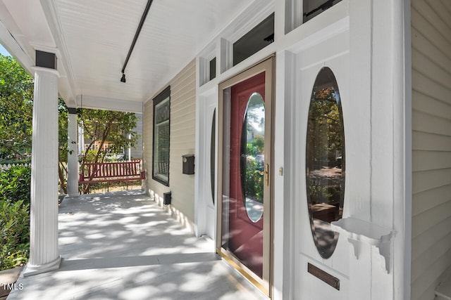 doorway to property featuring covered porch