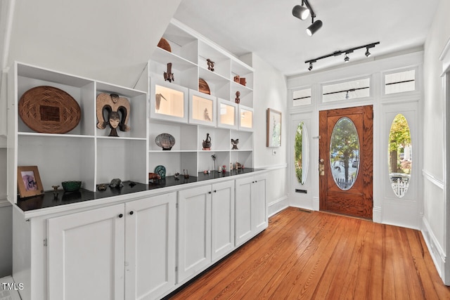 foyer entrance featuring rail lighting and light wood-type flooring