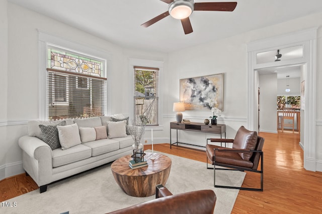 living room with light hardwood / wood-style floors and ceiling fan