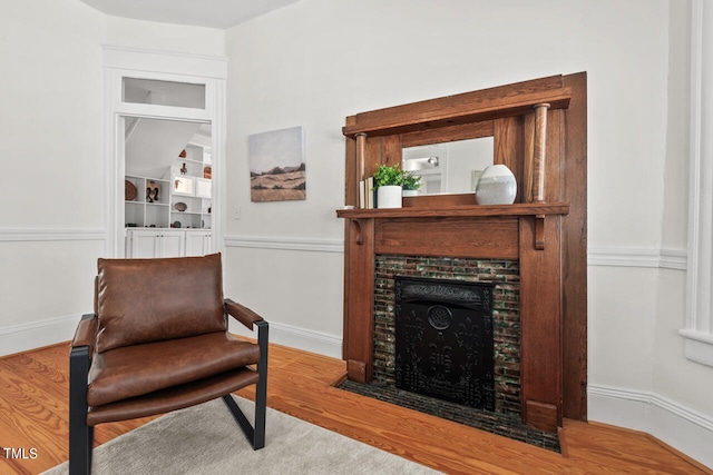 sitting room with wood-type flooring