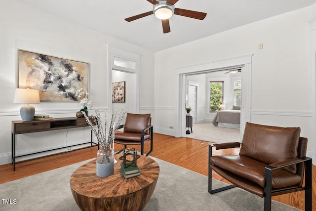 sitting room with light hardwood / wood-style floors and ceiling fan