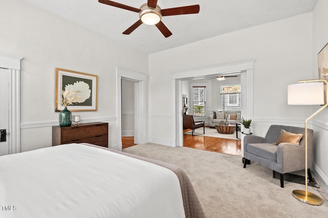 bedroom featuring light carpet and ceiling fan