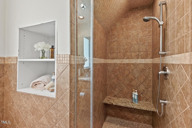 bathroom with vaulted ceiling and a shower with shower door