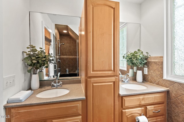 bathroom with vanity, a tile shower, and tile walls