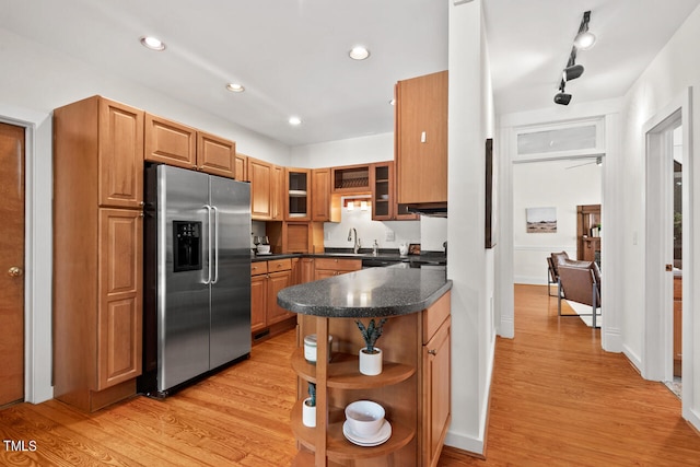 kitchen with sink, stainless steel fridge with ice dispenser, and light wood-type flooring