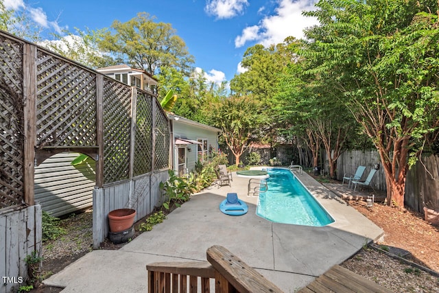 view of swimming pool with a patio area