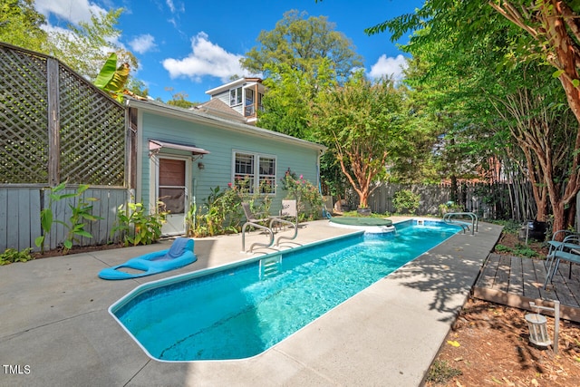 view of swimming pool with a patio area