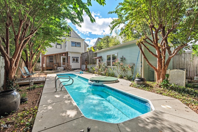 view of swimming pool with a patio and a deck