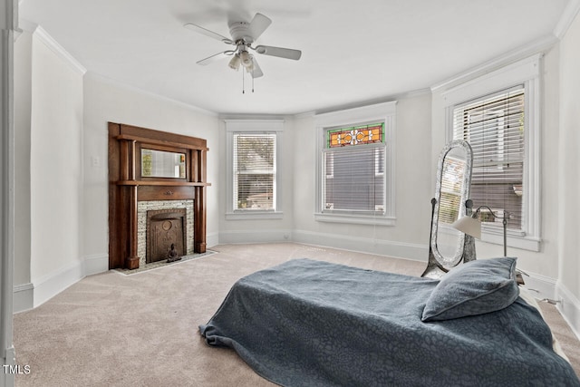 carpeted bedroom with ceiling fan and ornamental molding