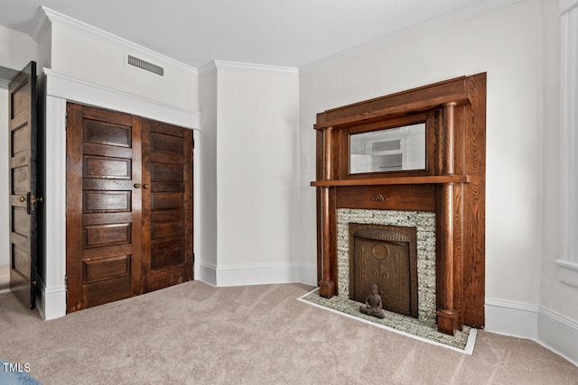 unfurnished living room featuring ornamental molding and carpet floors