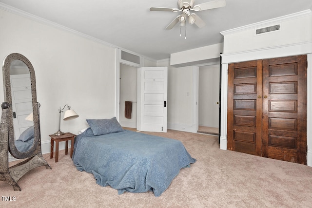 bedroom featuring ceiling fan, light carpet, and crown molding