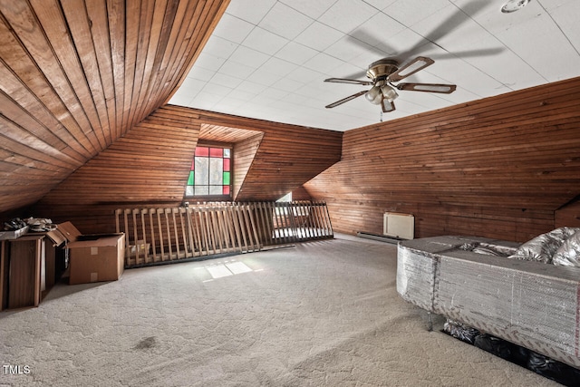 bonus room featuring ceiling fan, wood walls, carpet flooring, and wooden ceiling