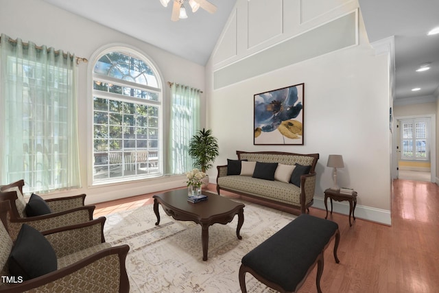 living area featuring wood finished floors, baseboards, high vaulted ceiling, recessed lighting, and ceiling fan