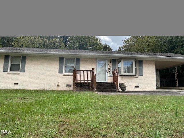 ranch-style house featuring a front lawn and a carport