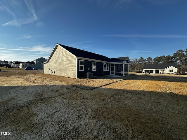 view of side of home featuring central AC