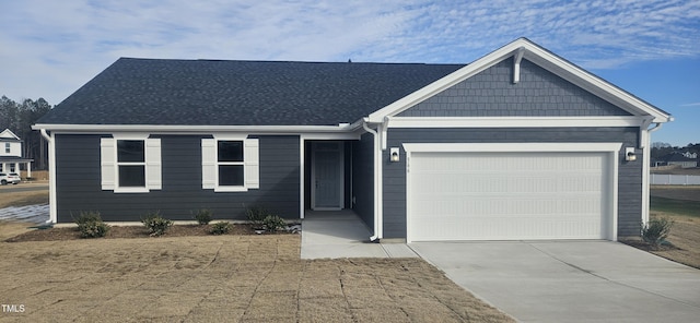 ranch-style home with an attached garage, a shingled roof, and concrete driveway