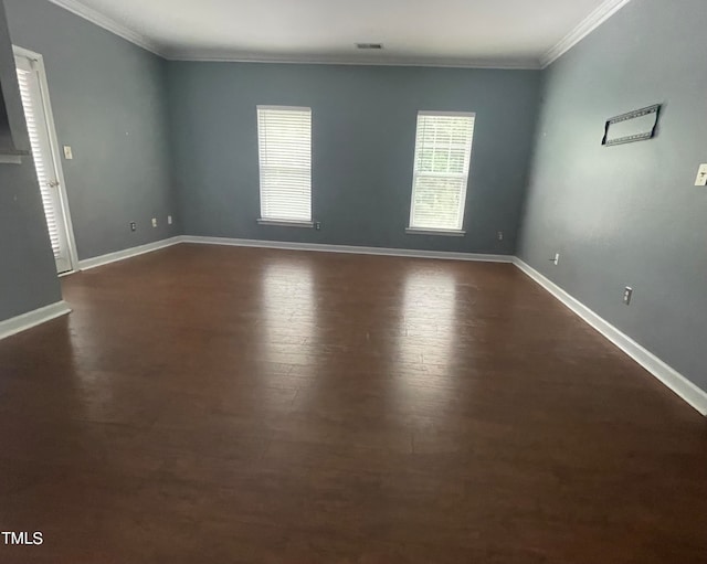 unfurnished room featuring crown molding and dark wood-type flooring