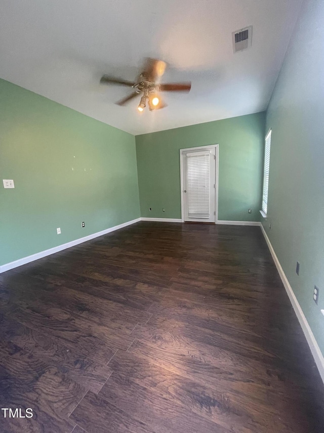 unfurnished room with dark hardwood / wood-style floors and ceiling fan