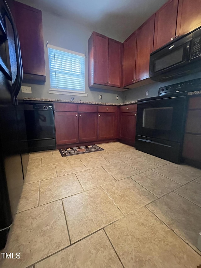 kitchen featuring light tile patterned floors and black appliances