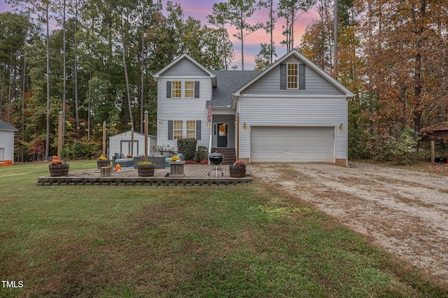 view of front of house featuring a garage and a yard