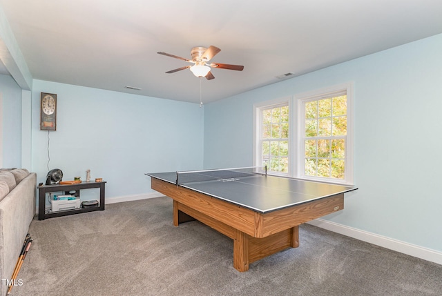 playroom with dark colored carpet and ceiling fan