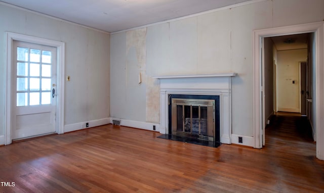 unfurnished living room featuring crown molding and hardwood / wood-style floors