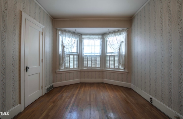 unfurnished room featuring dark hardwood / wood-style floors and crown molding