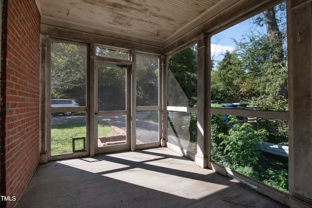 unfurnished sunroom featuring wood ceiling