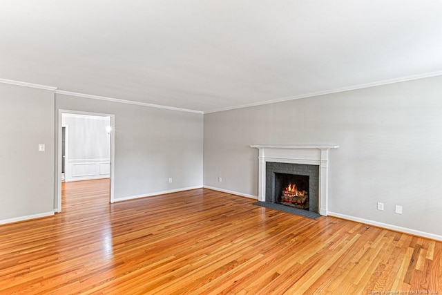 unfurnished living room featuring crown molding and light hardwood / wood-style flooring