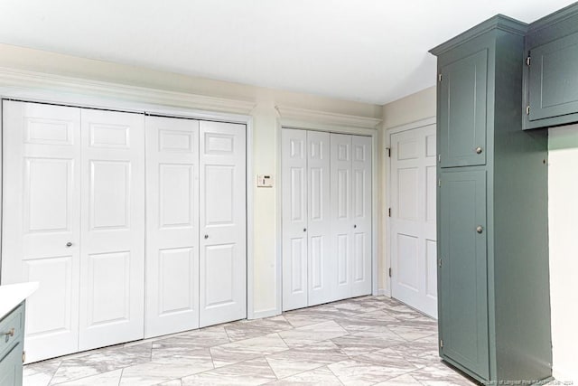 unfurnished bedroom featuring two closets