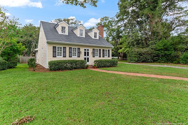 new england style home featuring a front yard