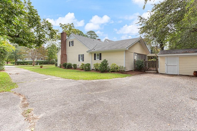 view of side of property with a lawn