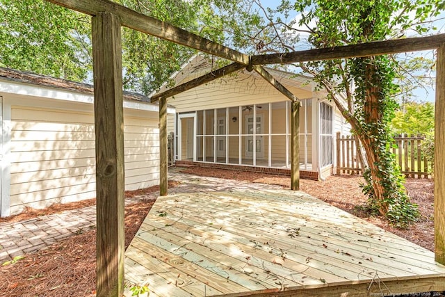 view of patio featuring a sunroom and a wooden deck