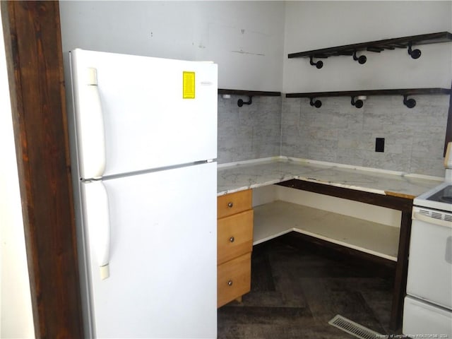 kitchen with tasteful backsplash and white appliances