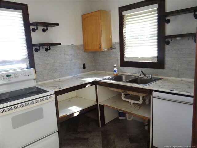 kitchen featuring backsplash, sink, and white electric range