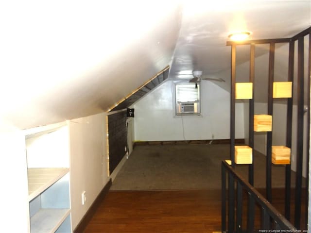 bonus room featuring ceiling fan, cooling unit, lofted ceiling, and dark wood-type flooring